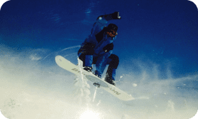 A person on a snowboard in the air.